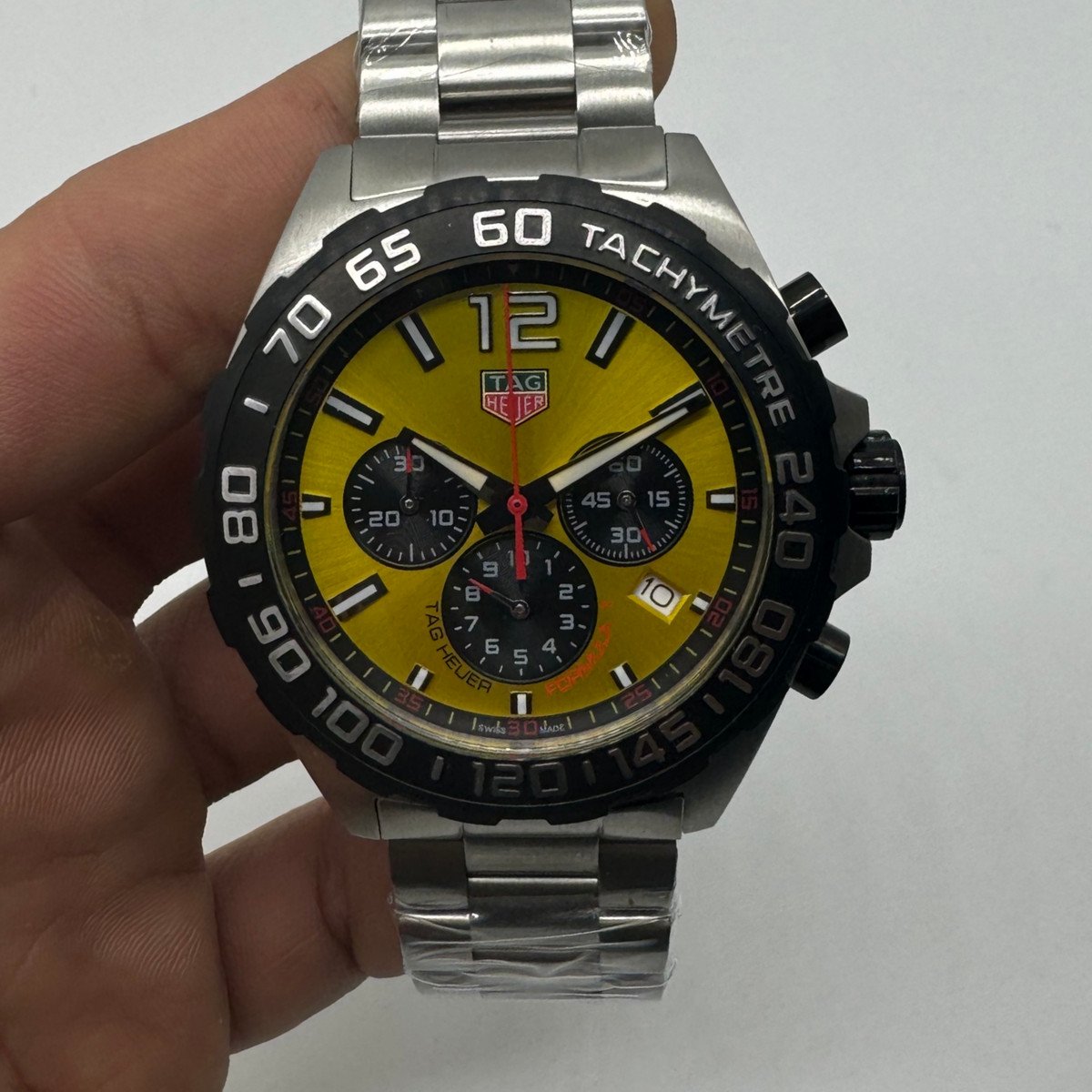a43f4e_57a66bf7891647b09d4b4451f432ae5cmv2 TAG Heuer F1 Cronometro 44mm Aço Mostrador Preto - Imagem 1